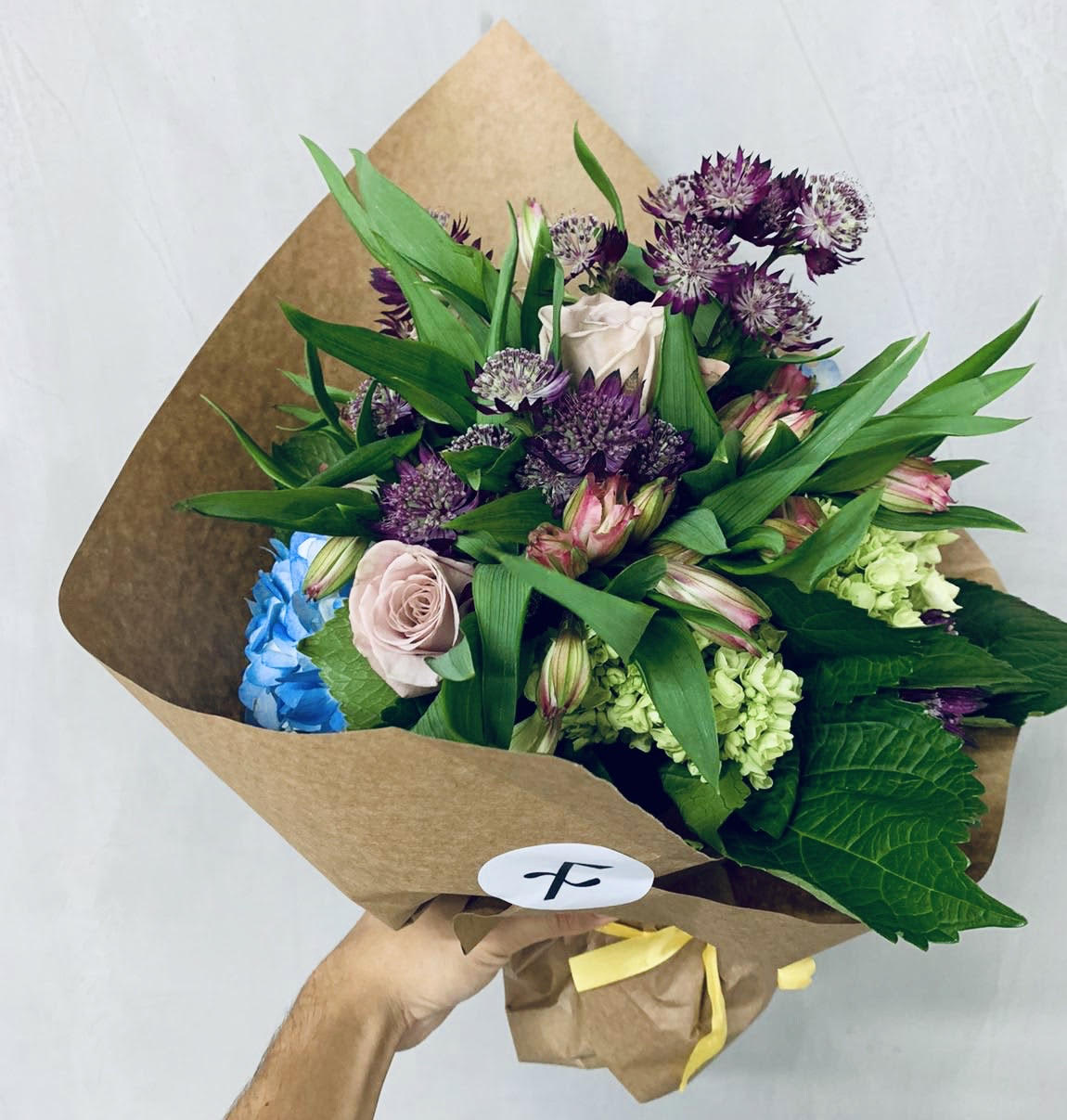 Silvestre bouquet of astrantia, alstroemeria, blue hydrangea and roses, hand-tied