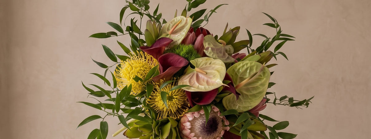 Anthurium and protea spread across the studio backdrop