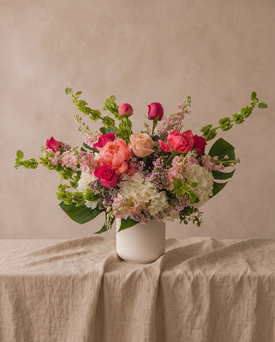 Blushing Beauty: roses, bells of Ireland and hydrangea in a white bowl