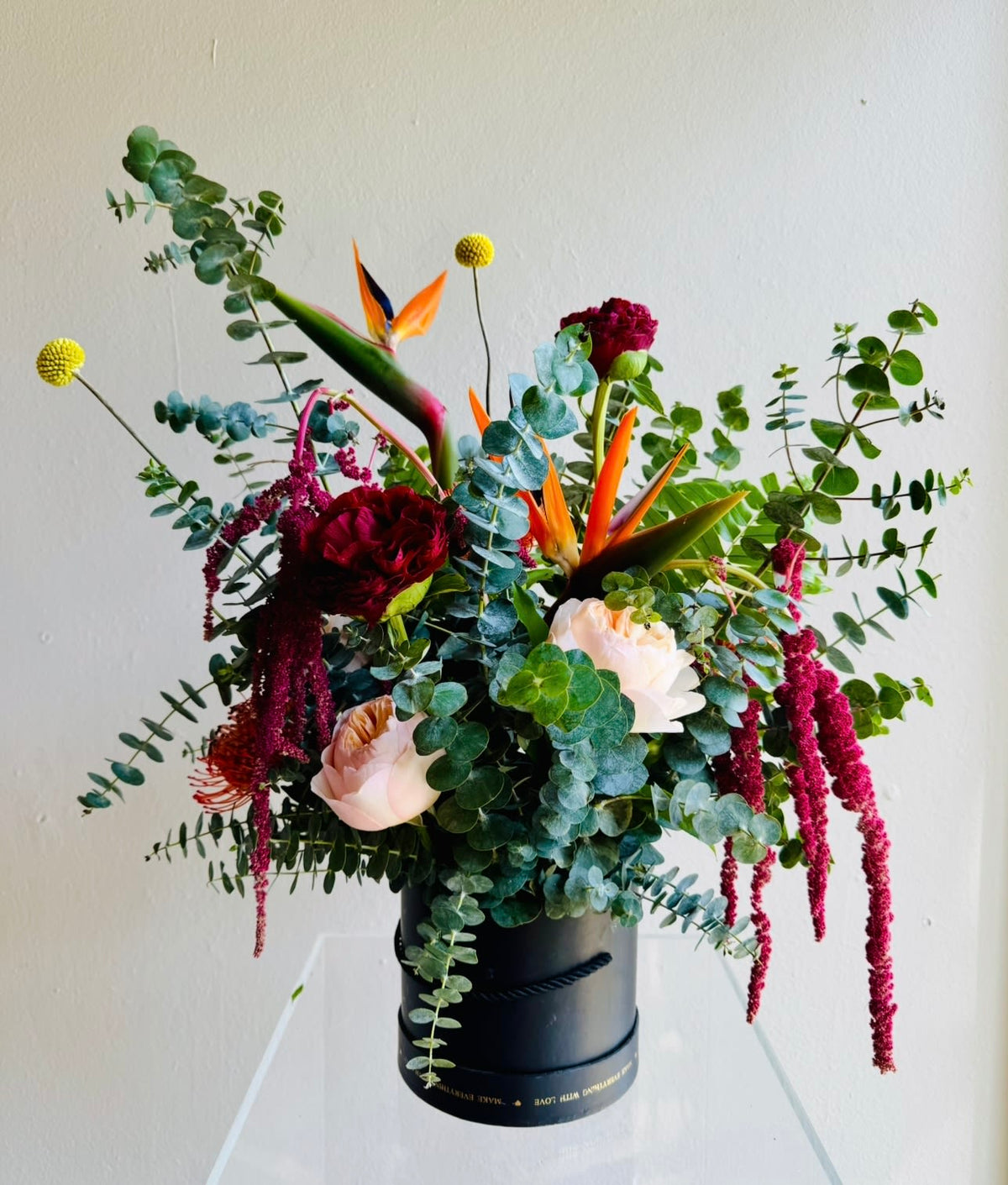 Fragrant Beauty arrangement of eucalyptus with birds of paradise, pincushions and garden roses