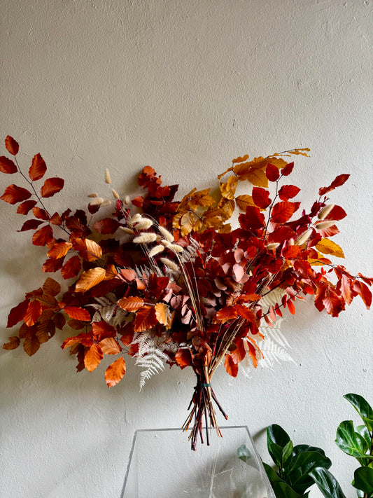 Autumn hand-tied bouquet of copper, rust and golden foliage with bunny tail grass and bleached ferns